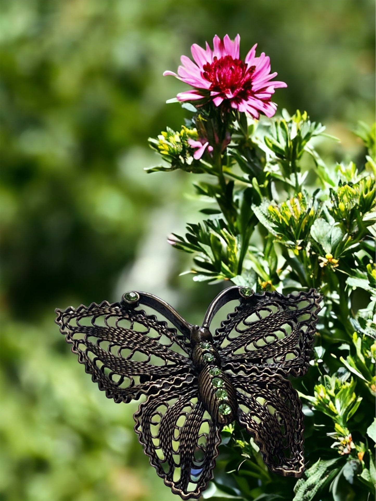 Detailed vintage filigree butterfly pin with tiny emerald green rhinestones