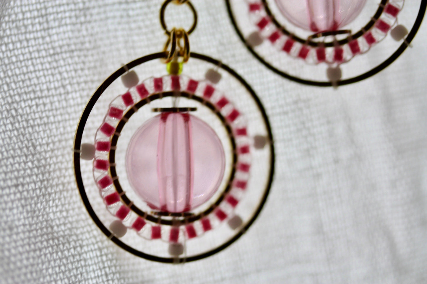 Pink and white intricate beadwork small circular dangle earrings