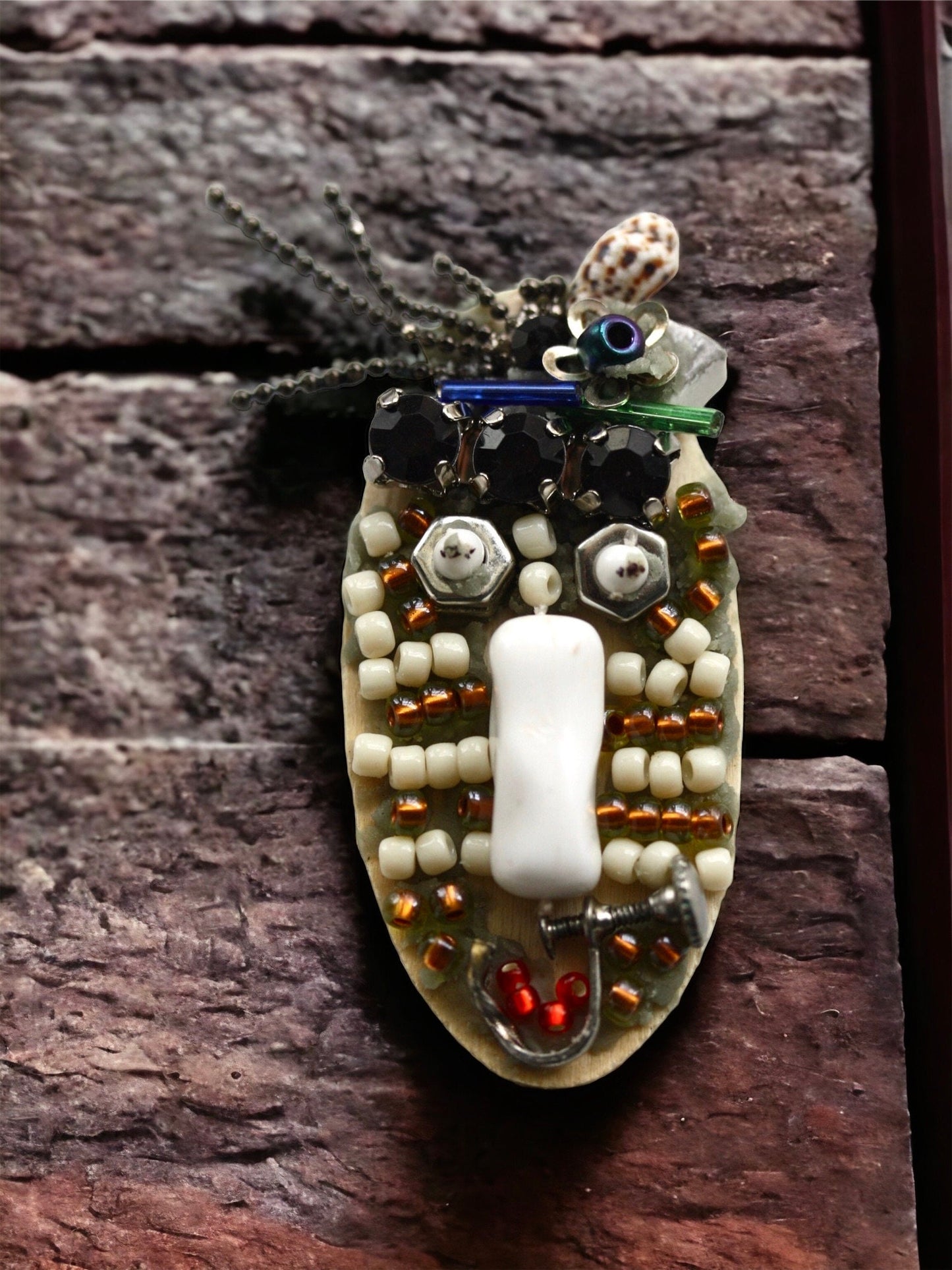 Meet "Sabina."  Sabina is a really cool assemblage art gal who can be transformed into a necklace, pin or magnet