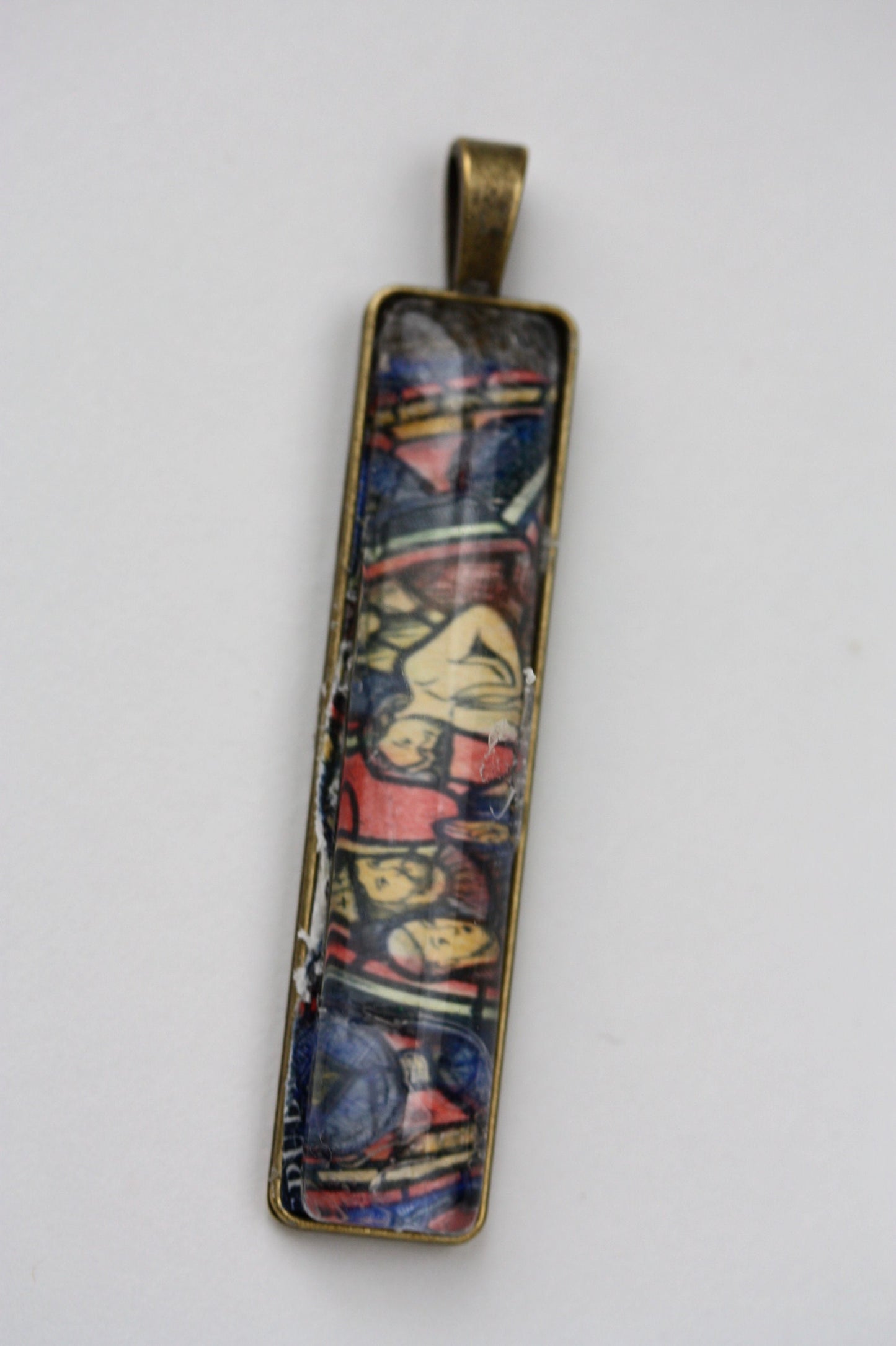 Necklace pendants made from genuine vintage and antique postage stamps from around the world - saints, Australian plane, Wicca  sun and moon