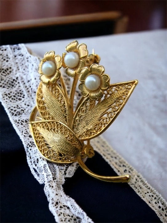 Detailed vintage filigree floral pin with faux pearls