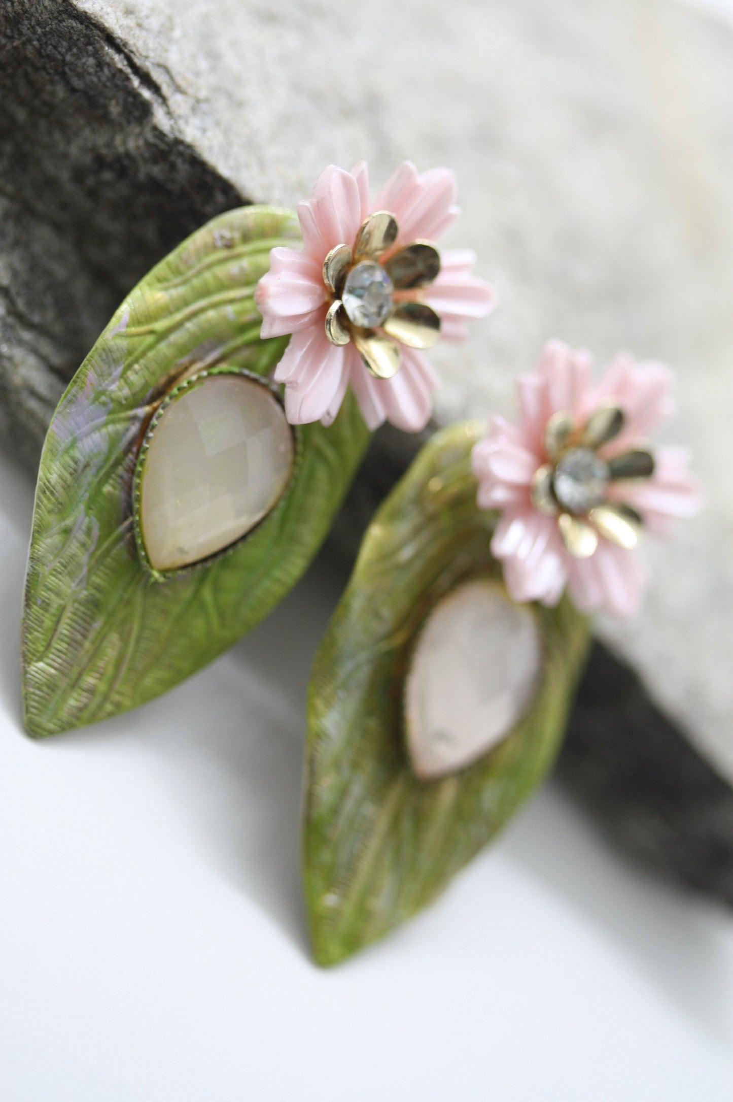 Hand painted leaf earrings with inlaid cabochan, vintage mixed material pink and metal flowers and capped off with rhinestone center