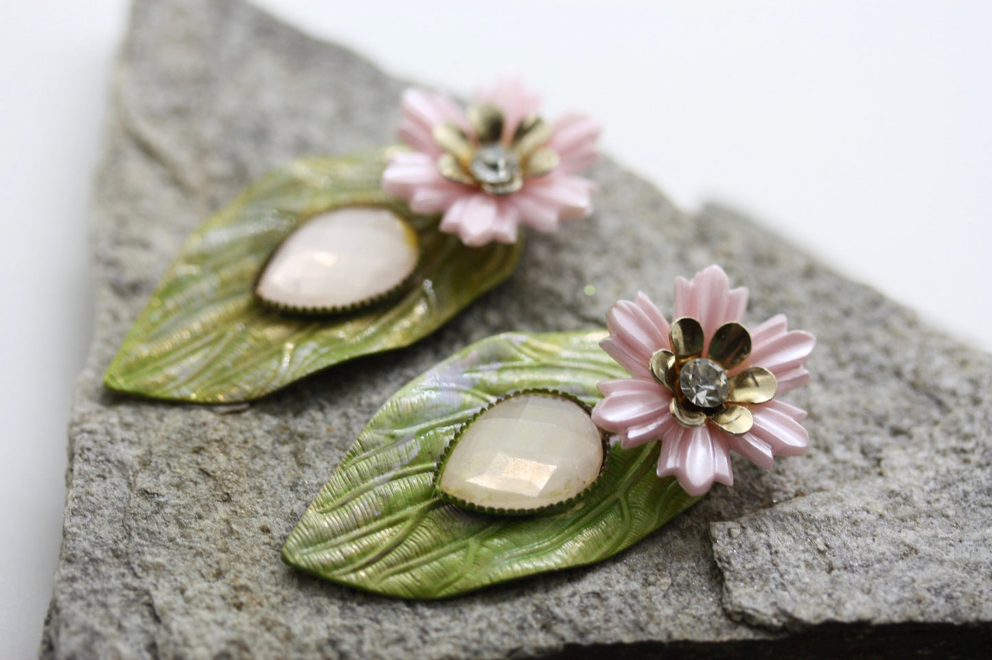 Hand painted leaf earrings with inlaid cabochan, vintage mixed material pink and metal flowers and capped off with rhinestone center