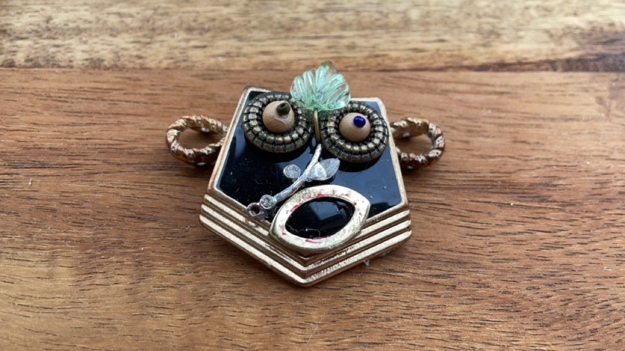 This monkey is a really cool assemblage art piece - it can be transformed into a necklace pendant, pin, magnet, small ornament or ring
