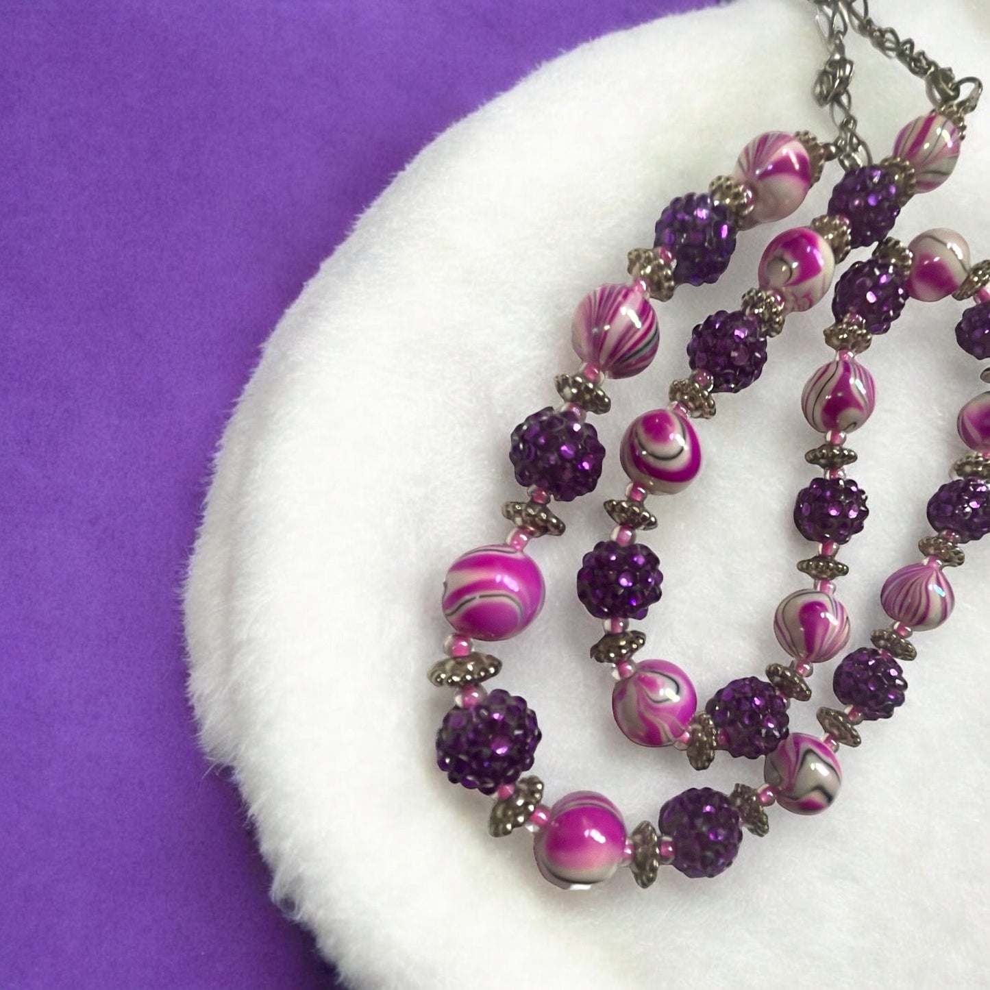Shades of pinkish purple swirled vintage necklace with purple rhinestone beaded balls
