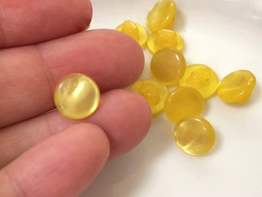 One dozen round yellow gold pearlescent vintage buttons