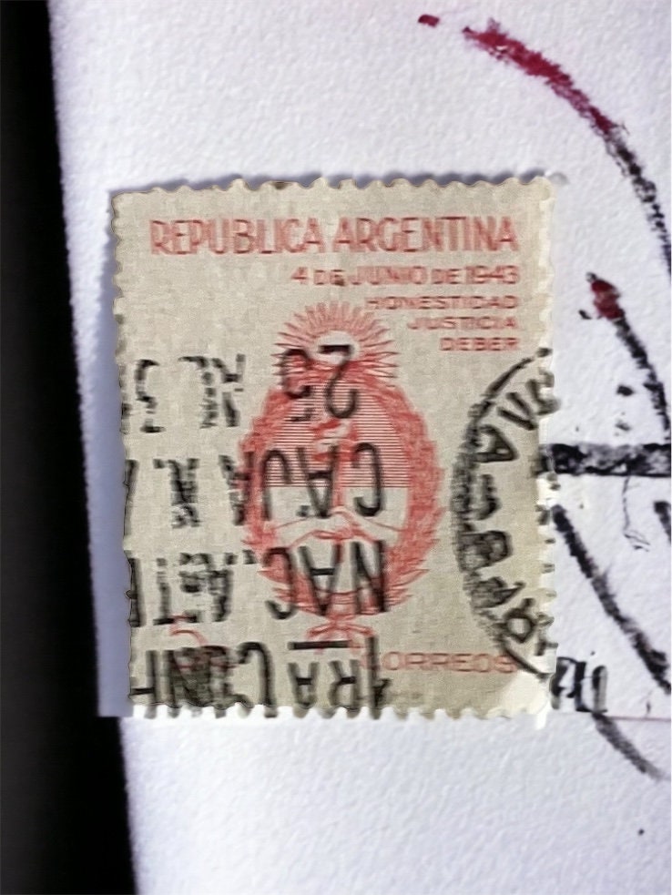 Pendant or pin made from a genuine vintage postage stamp from Argentina