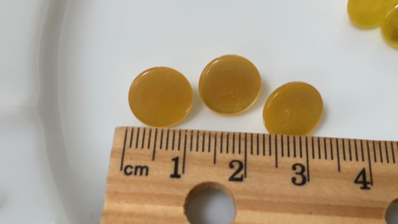 One dozen round yellow gold pearlescent vintage buttons