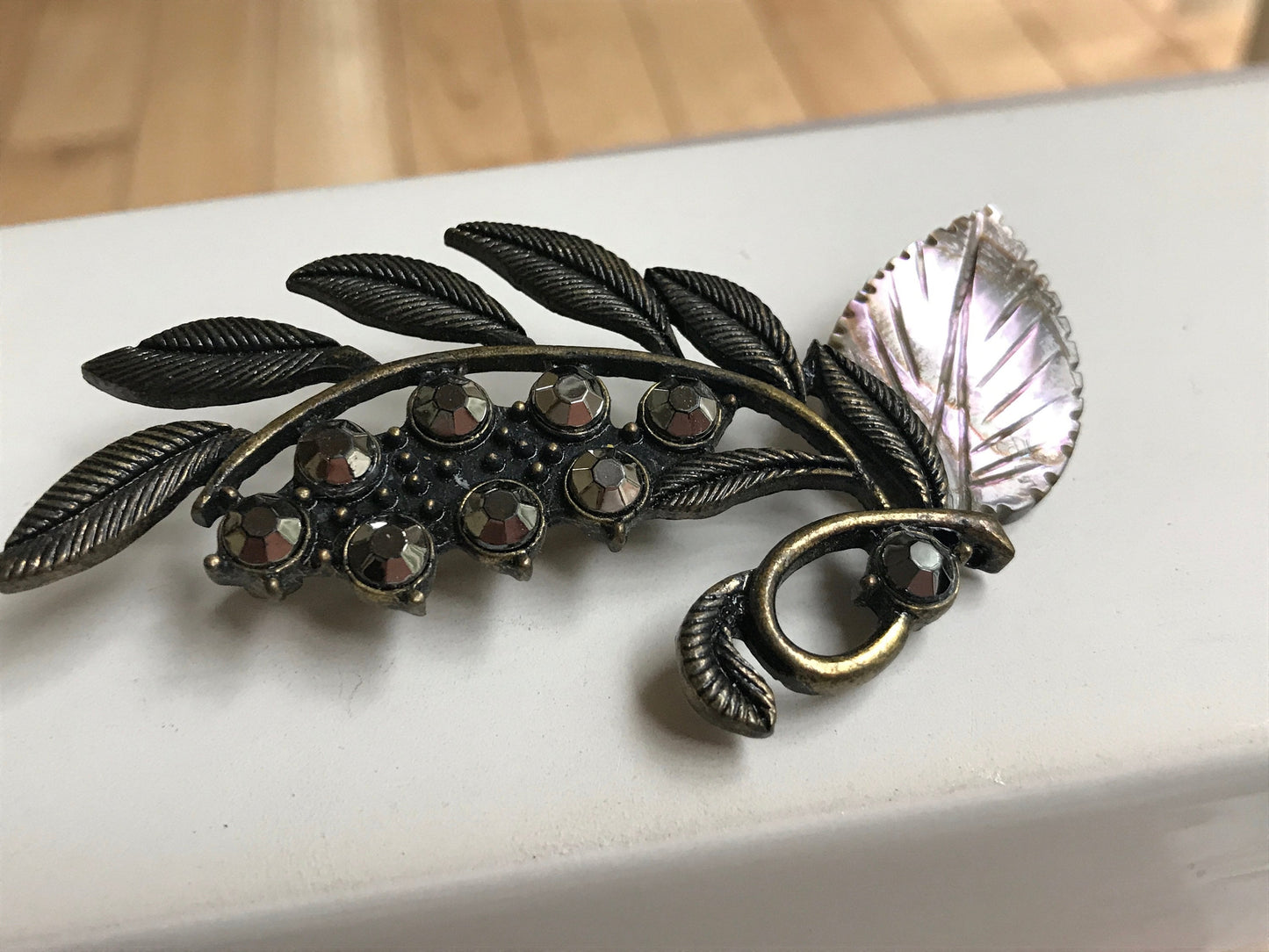Stunning and unique vintage metal and rhinestone pin with abalone leaf