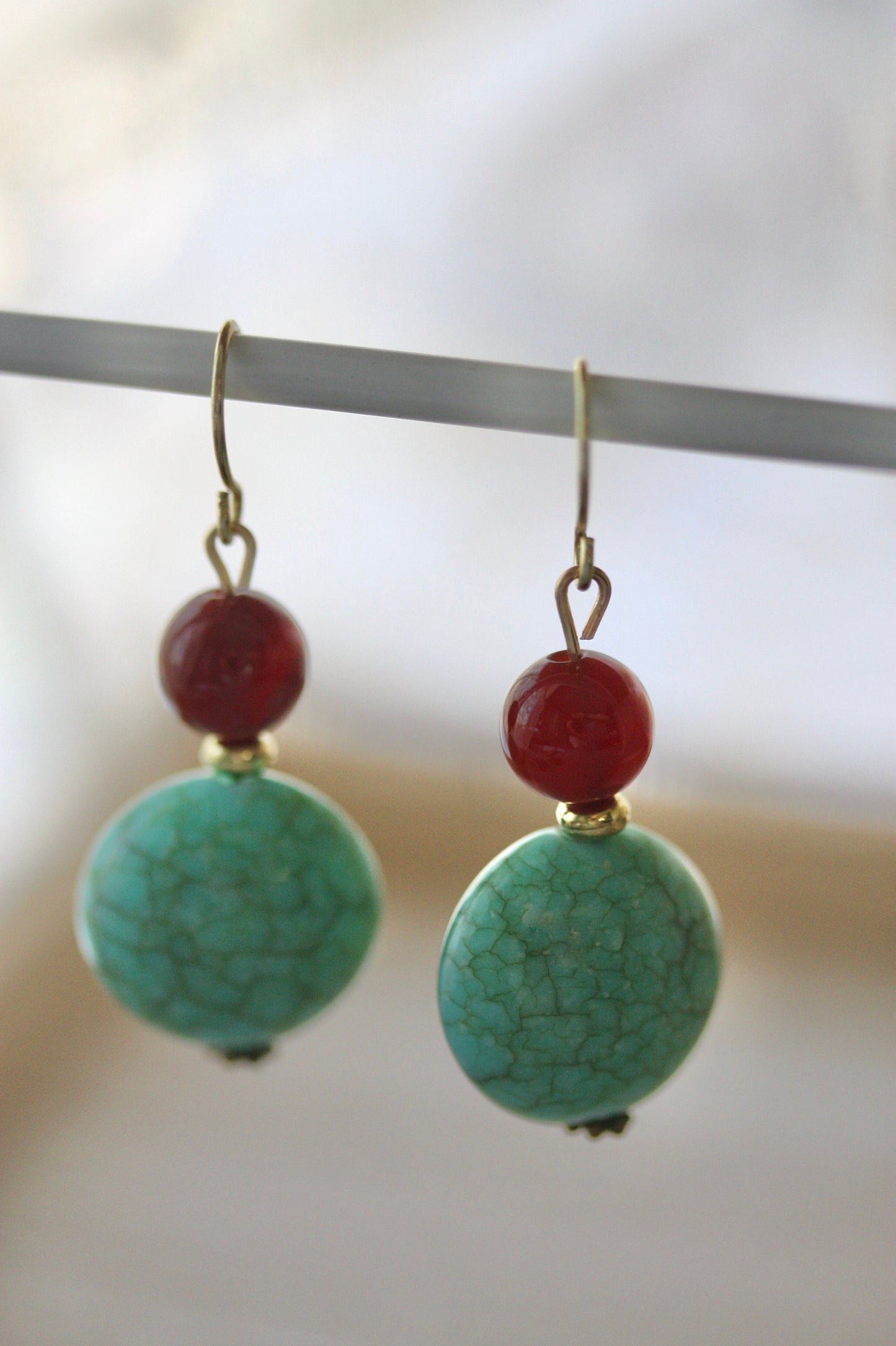Dangle earrings made of faux turquoise and deep red glass