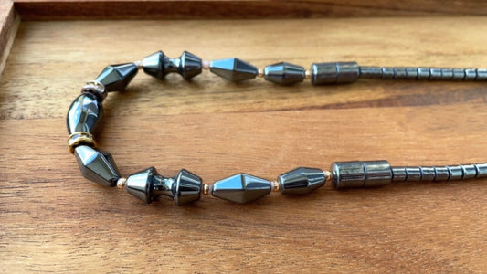 Vintage hematite necklace with uniquely shaped hematite beads and rhinestone spacers