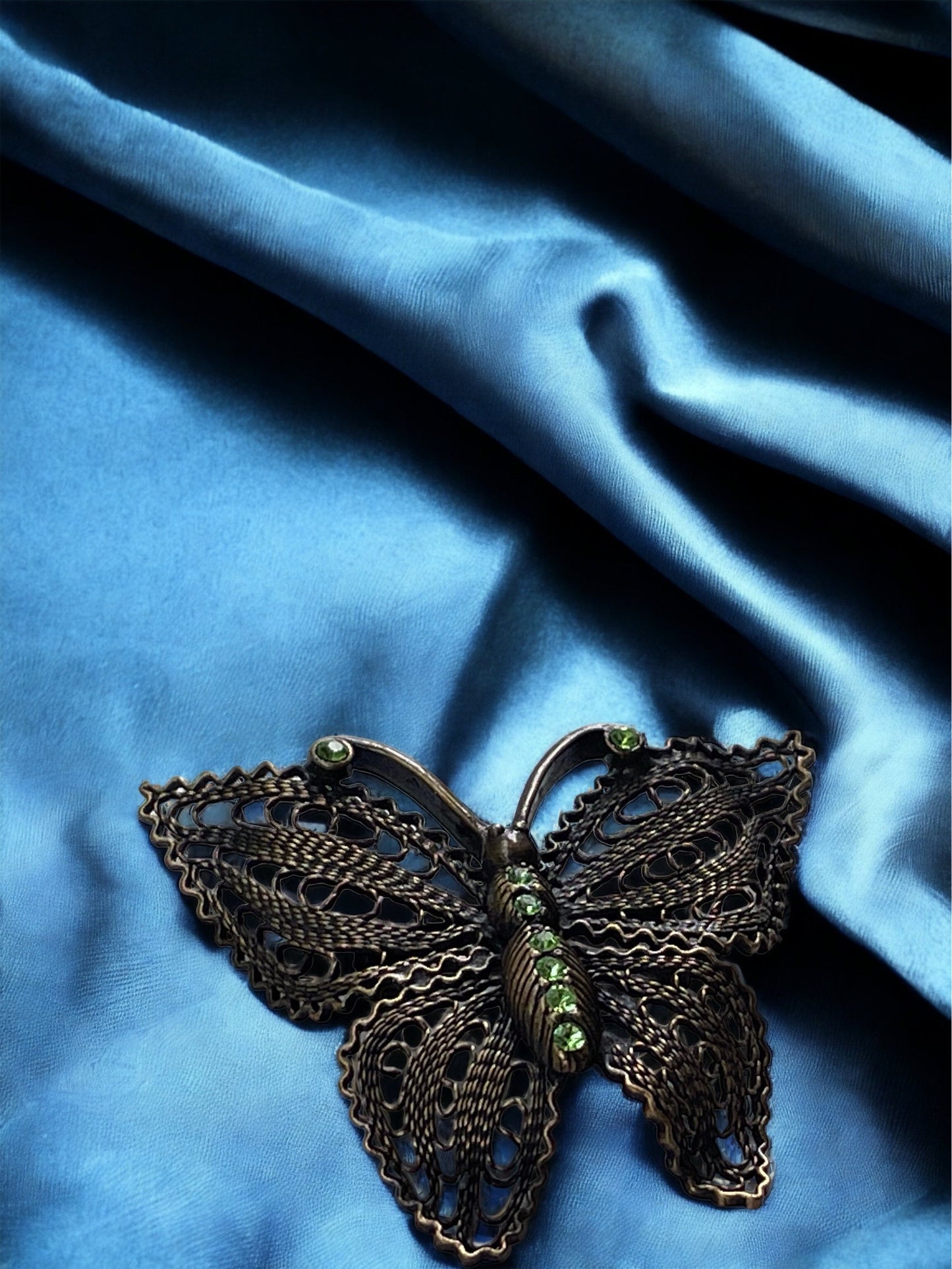 Detailed vintage filigree butterfly pin with tiny emerald green rhinestones