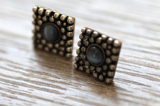 Textured metal vintage square stud earrings with blue glass inlay