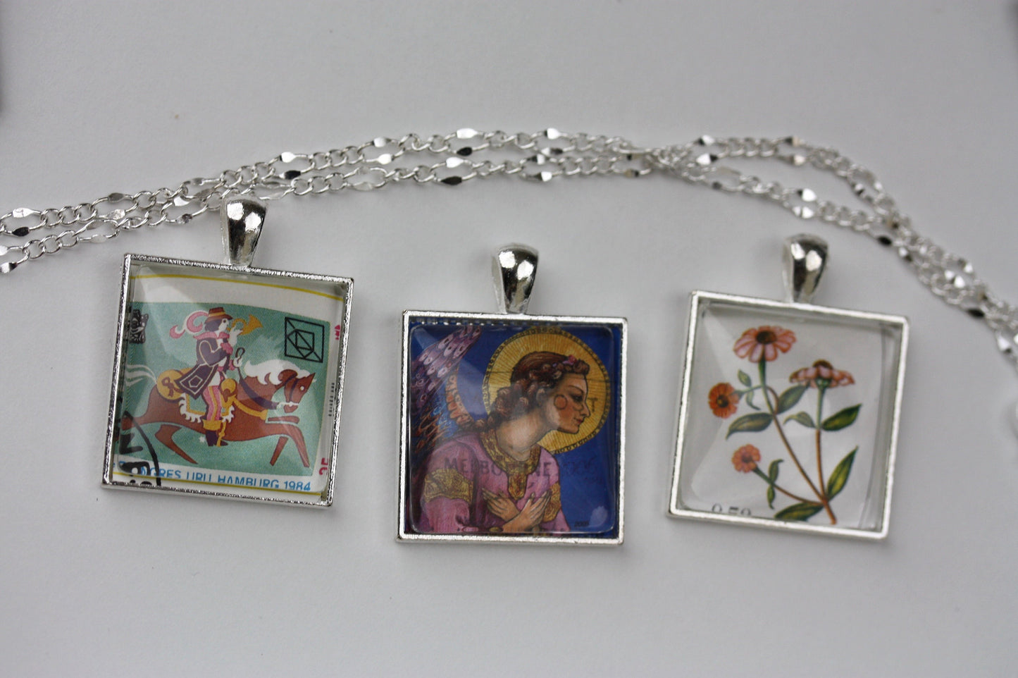 Necklace pendants made from genuine vintage and antique postage stamps from around the world - Australia, Argentina, Afghanistan, folk art