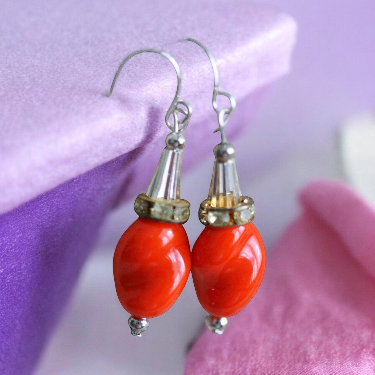 Unique dangle earrings featuring orange free form slightly twisted vintage glass, metal cone beads and rhinestone spacers