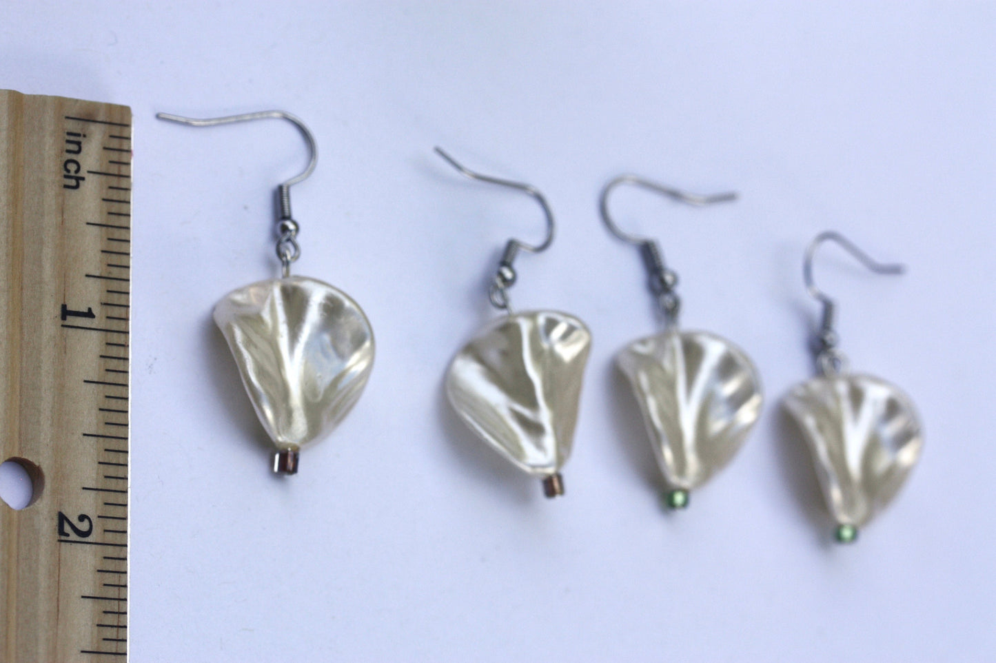 Pearlescent leaves dangle earrings trimmed with tiny sparkly seed beads