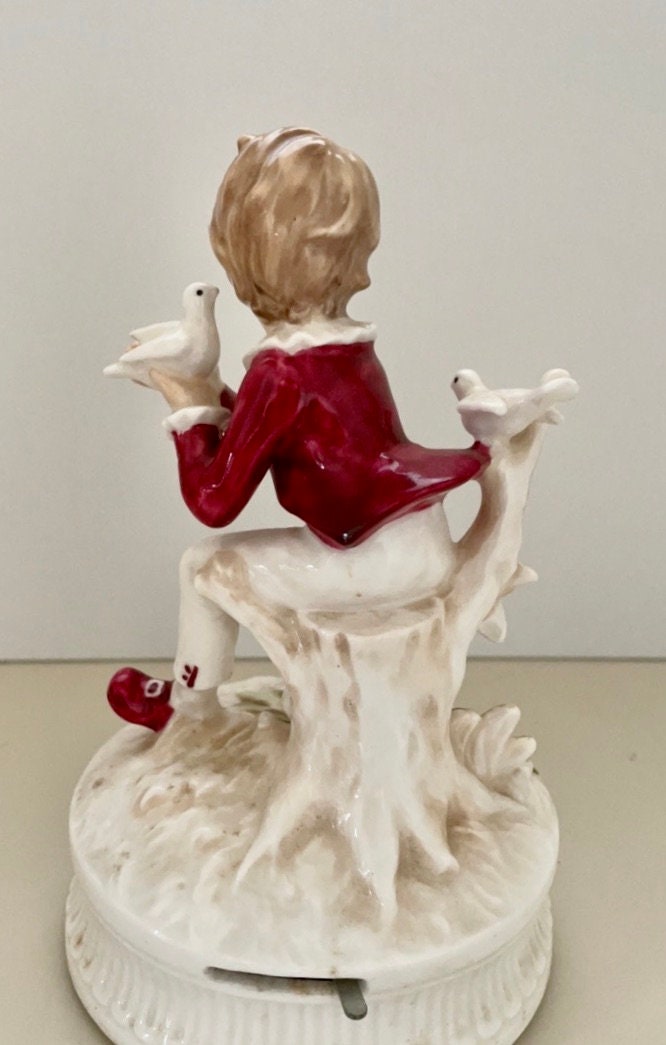 1977 Berman and Anderson stunning porcelain music box - boy dressed in red and white feeding birds