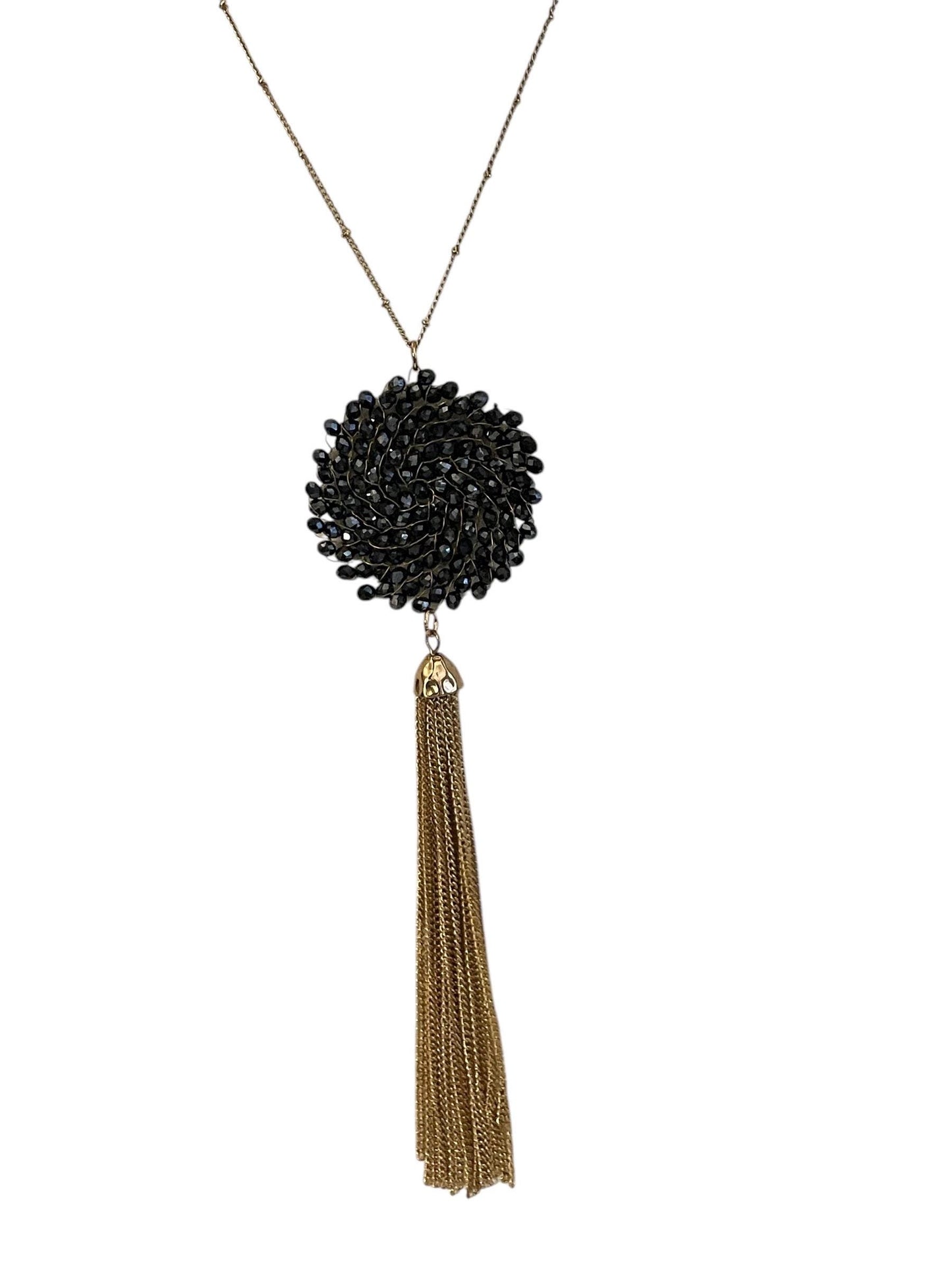 Vintage necklace featuring a black crystal wire linked circular pendant with long goldtone tassel