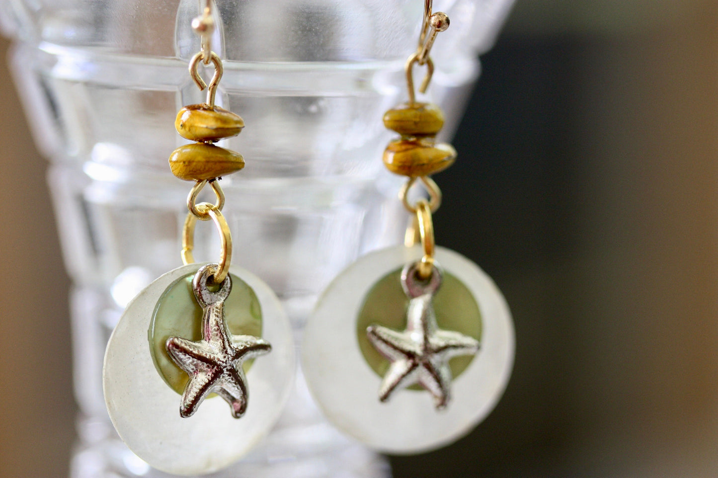 Mixed materials - green mother of pearl, metal starfish and yellow wood - beach themed dangle earrings