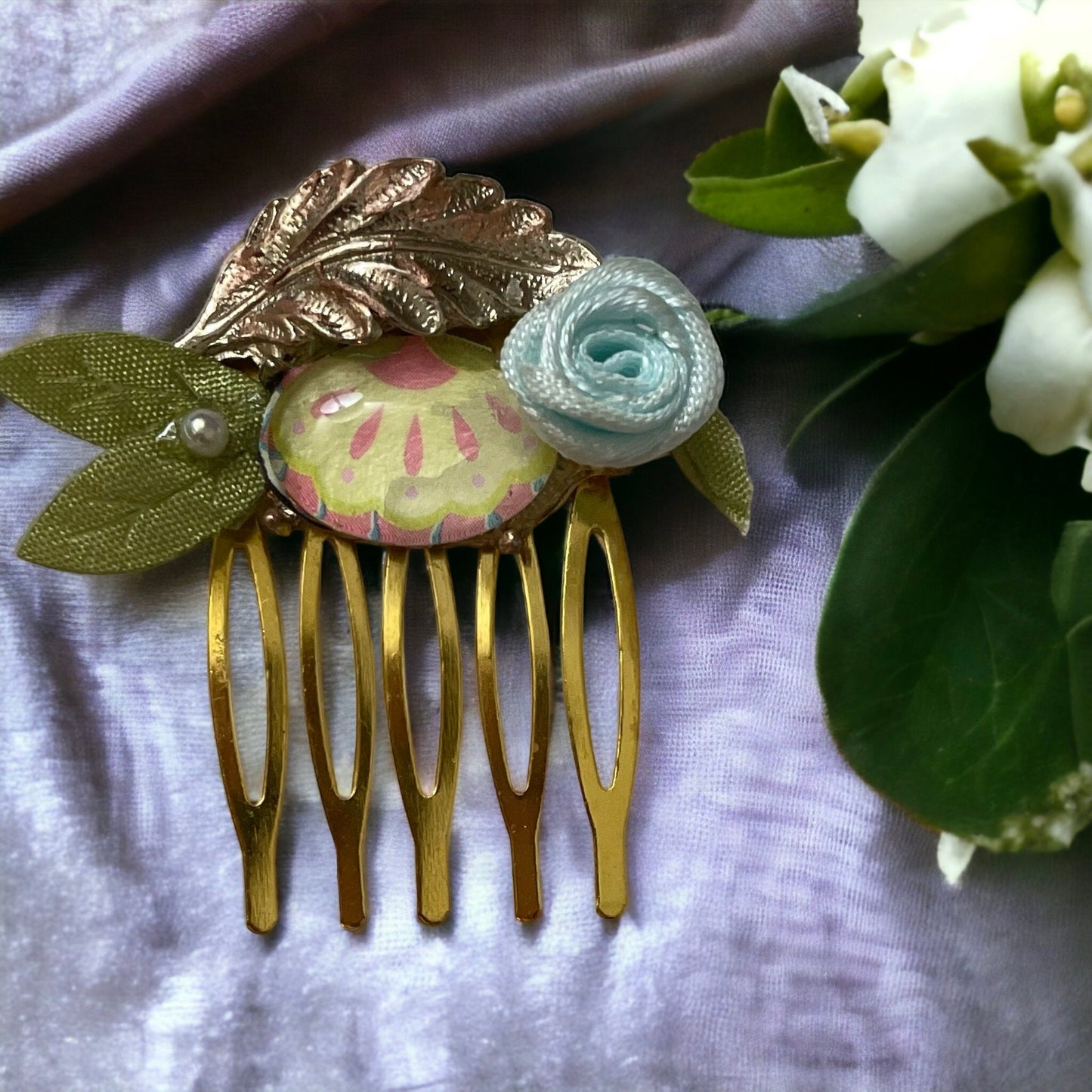 Garden inspired mixed material small 1" hair comb with antiqued metal leaf, paper sealed glass cabochon, satin flower/leaves
