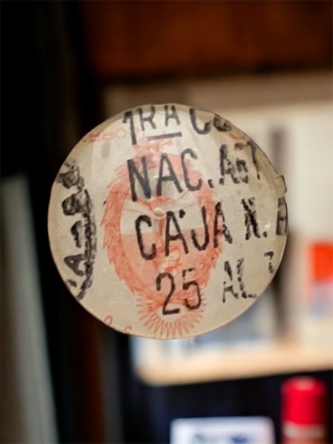 Pendant or pin made from a genuine vintage postage stamp from Argentina