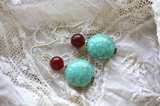 Dangle earrings made of faux turquoise and deep red glass