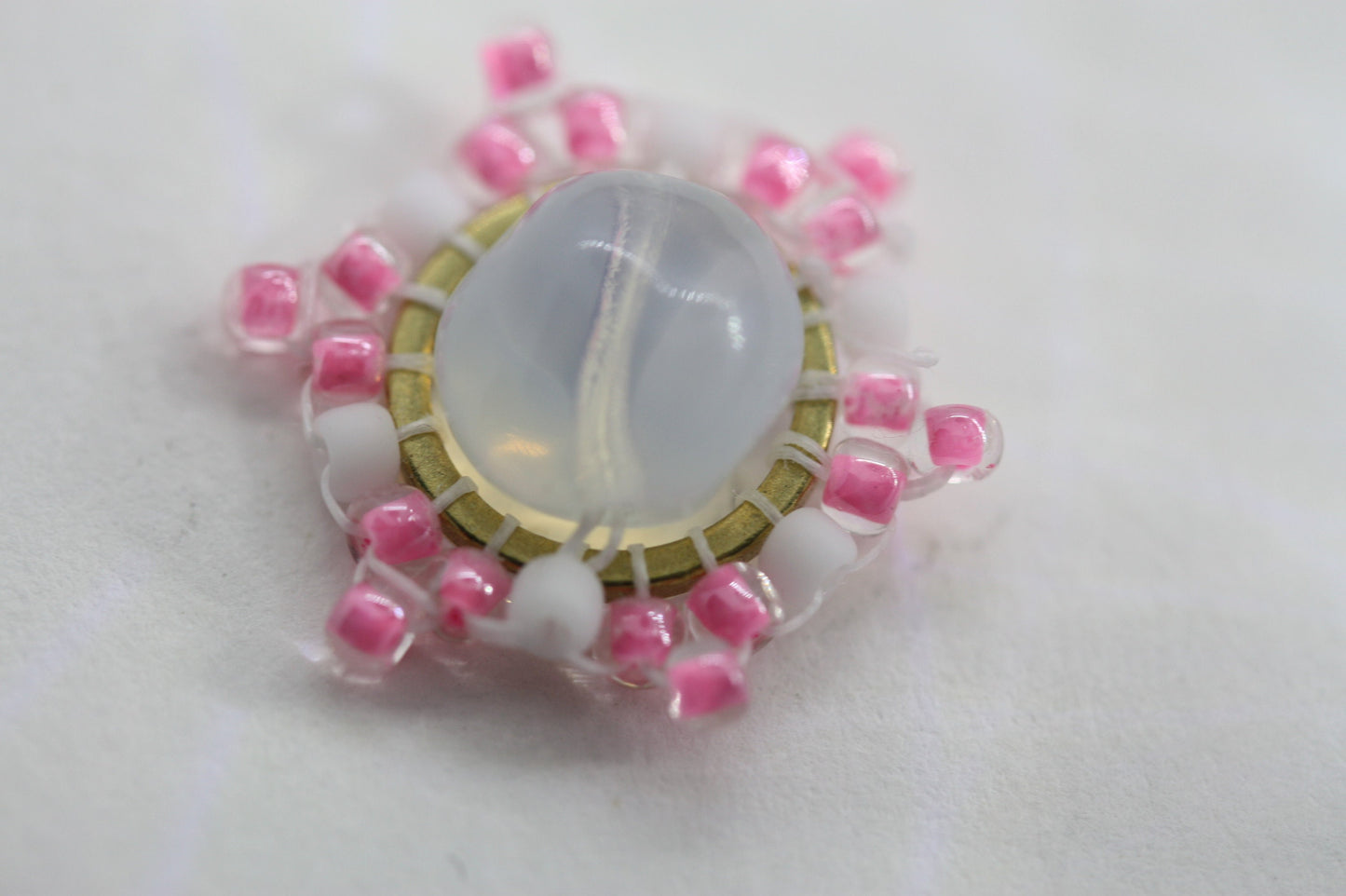Hand beaded stud earrings - pink and white beadwork around transluscent opalescent glass bead