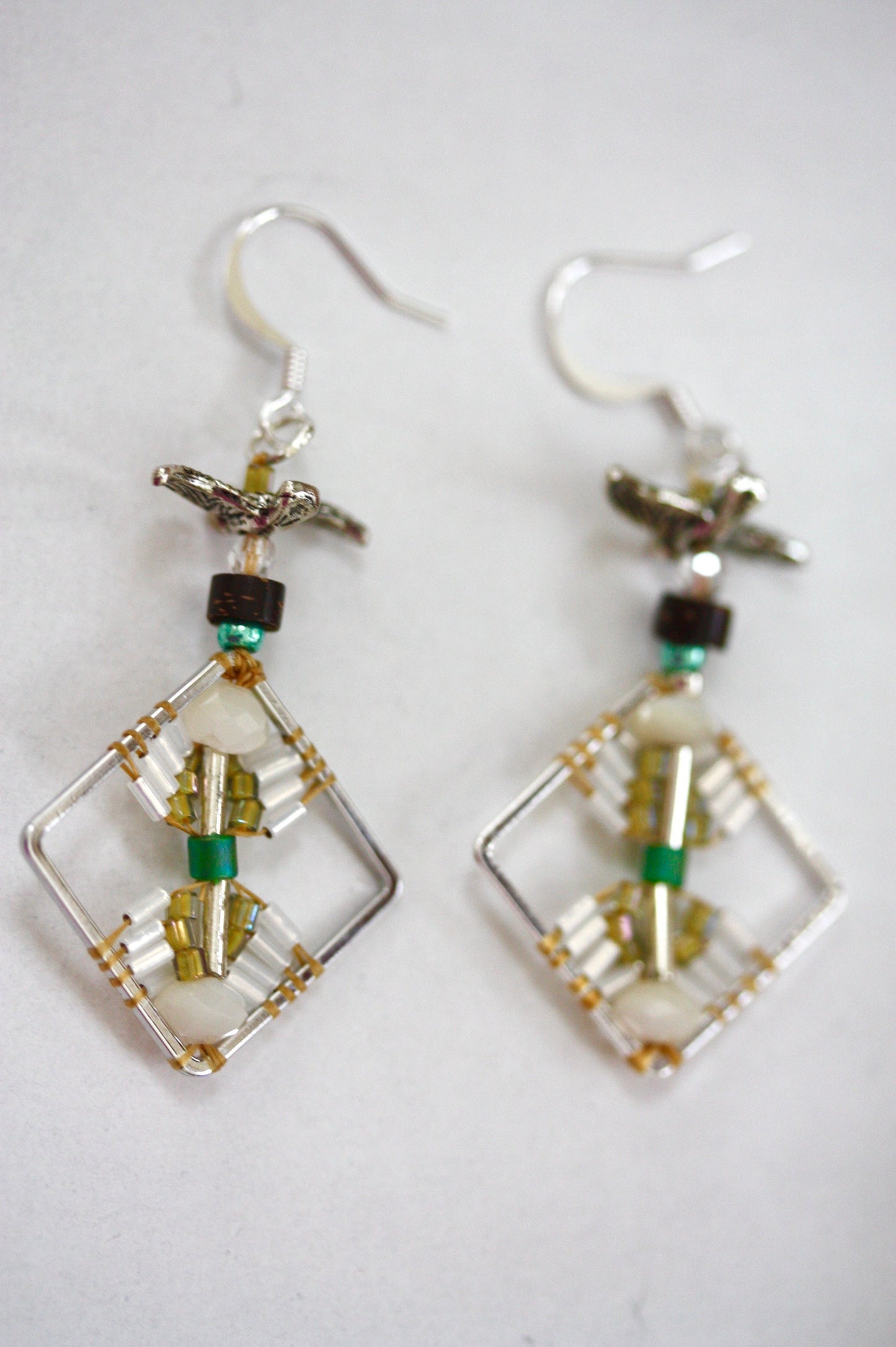 Birds taking flight - intricate beadwork seed bead dangle earrings on diamond-shaped base with flying bird embellishments