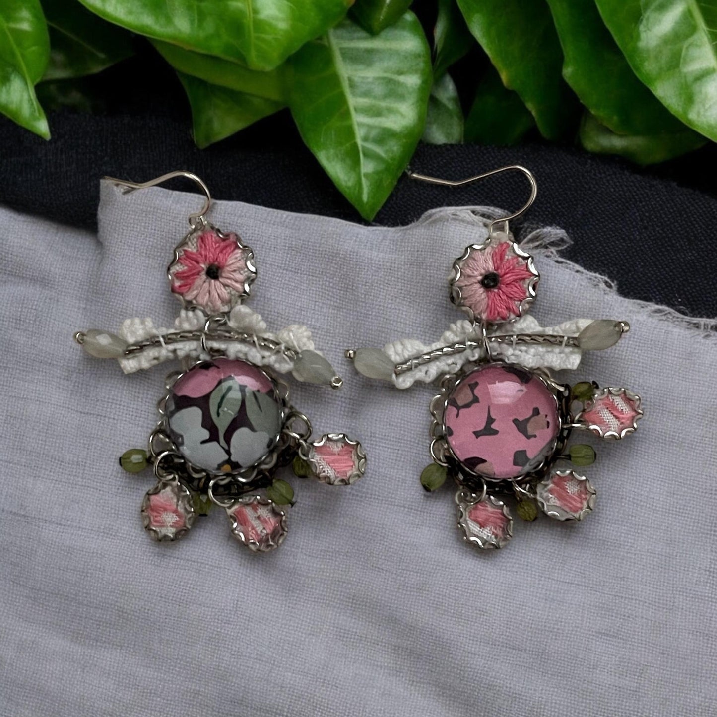 Mixed media earrings made with vintage crochet lace, embroidery from a vintage linen table runner, paper, satiny ribbon and mixed metals