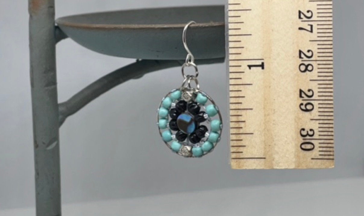 Small dangling handmade turquoise and black beadwork earrings with abalone centers