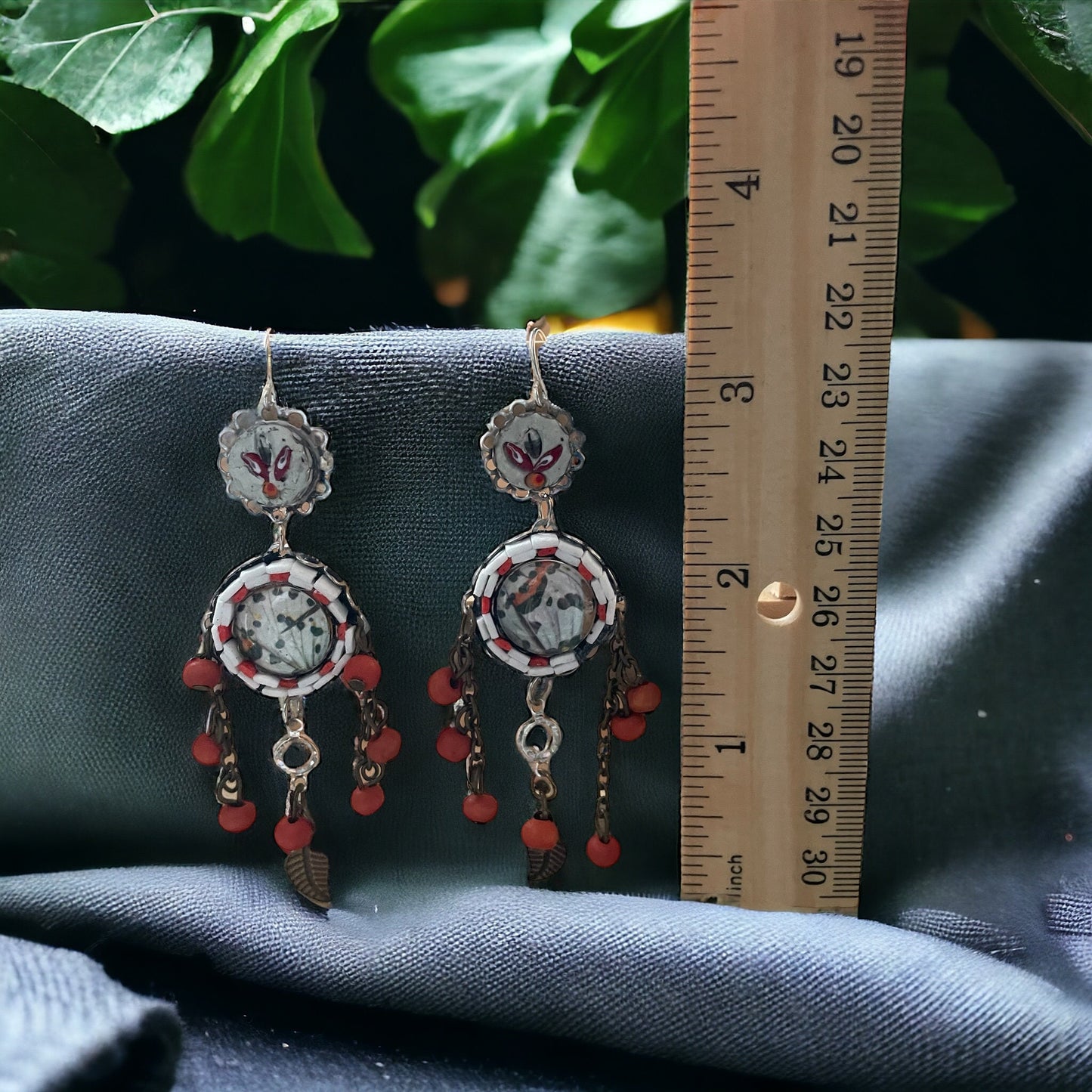 Hand cut micro mosaic millefiori glass dangle earrings surrounding butterfly wing image with orange wood dangles and feather charms
