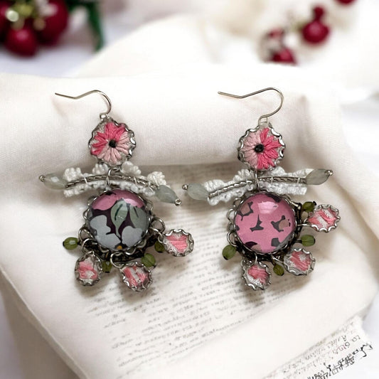 Mixed media earrings made with vintage crochet lace, embroidery from a vintage linen table runner, paper, satiny ribbon and mixed metals
