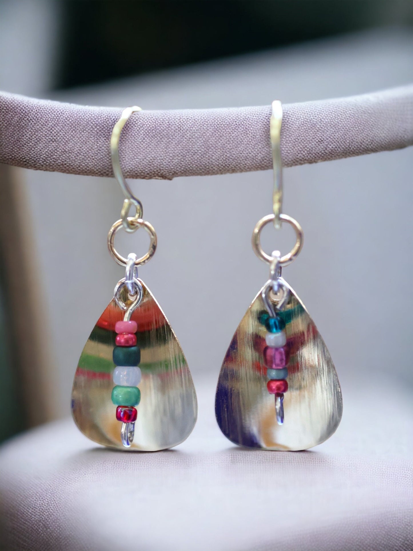 Gently curved silver leaf drop earrings with colored glass seed bead dangles