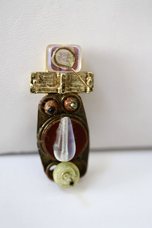 Meet "Joe."  Joe is a really cool assemblage art guy who can be transformed into a necklace, pin, magnet or ring