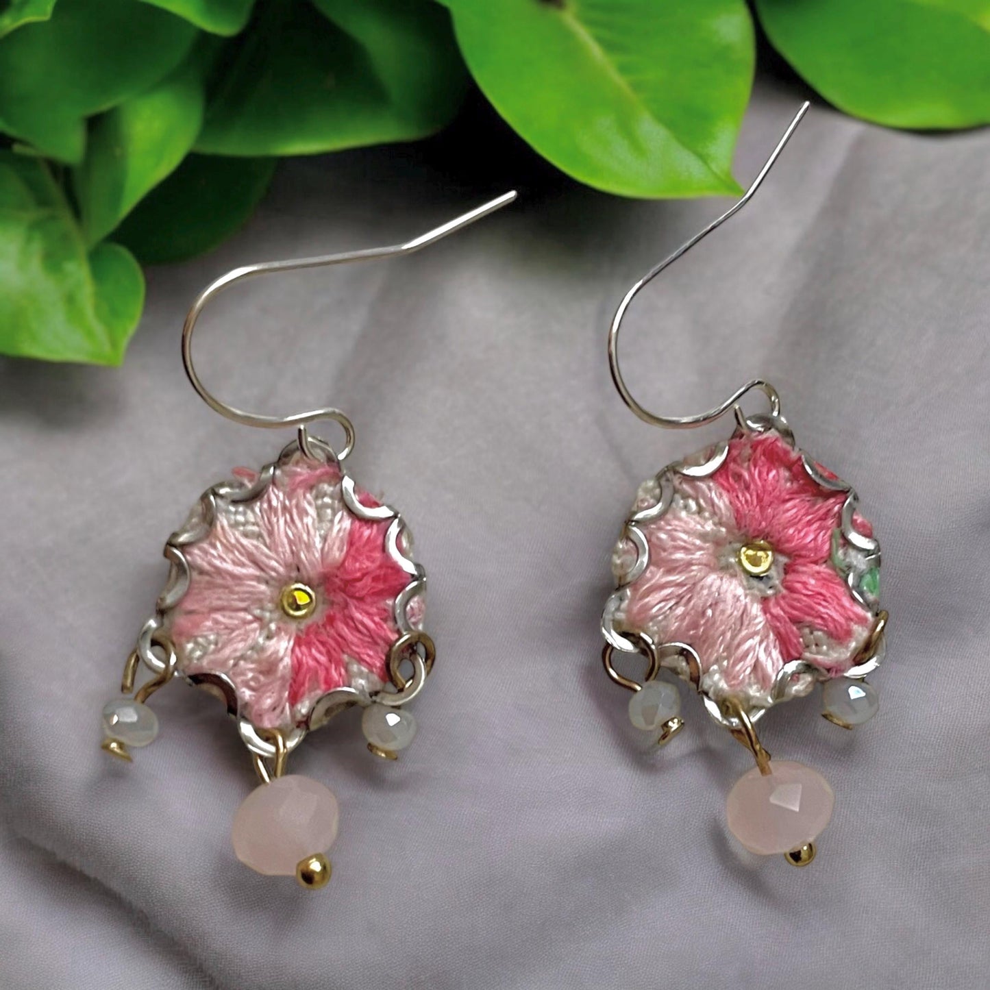 Handmade shades of pink mixed media earrings made with embroidery from a vintage linen table runner, combined with tiny dangles