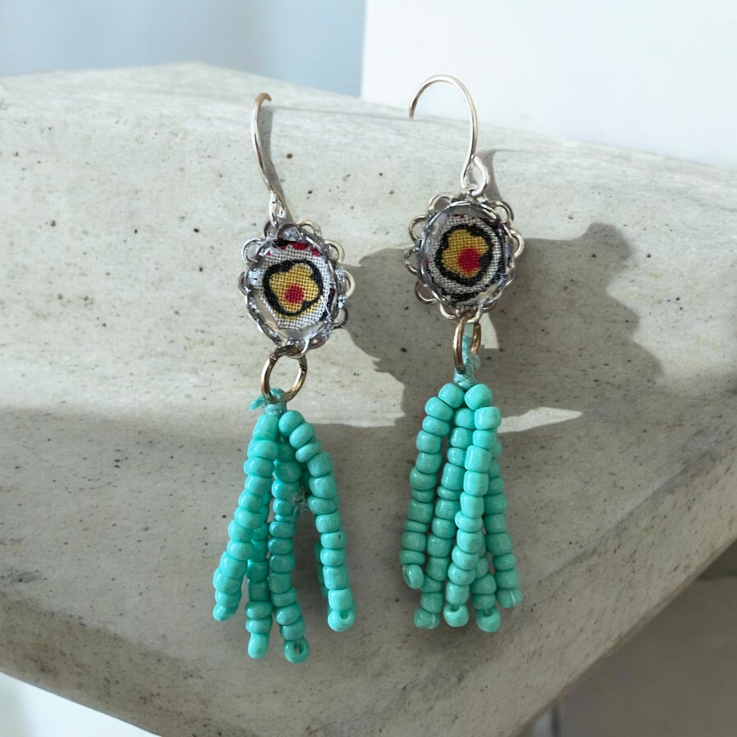 Handmade mixed media earrings featuring beaded turquoise tassel combined with vintage fabric snippets.  Sterling silver ear wire.