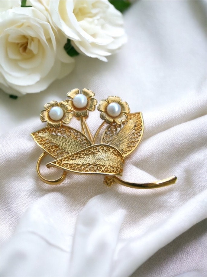 Detailed vintage filigree floral pin with faux pearls