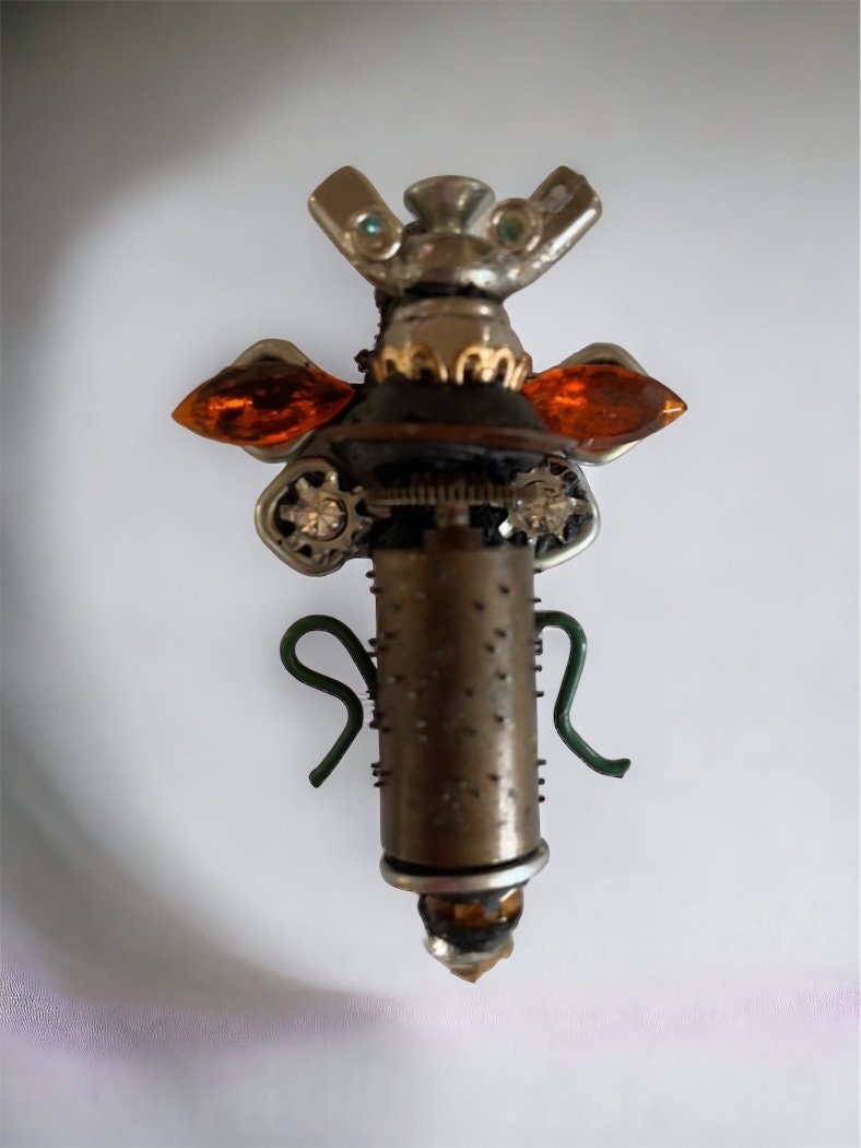 Meet "Scout" , a mixed material insect made of parts of a vintage Swiss music box, along with nails, screws, bolts - pin or necklace pendant