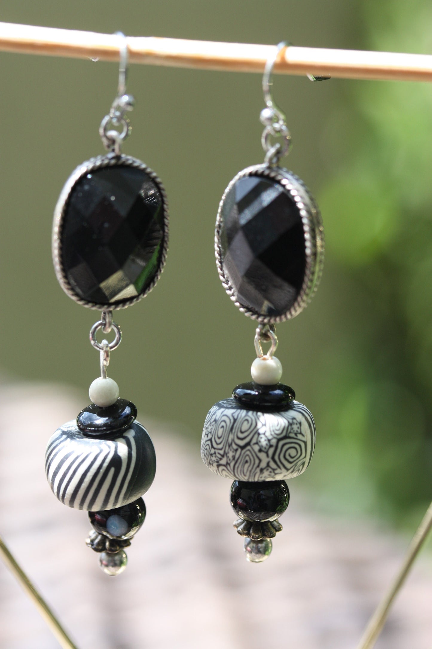 Black and white mixed media earrings made of upcycled polymer clay, combined with vintage black faux crystal, metal and glass spacer beads