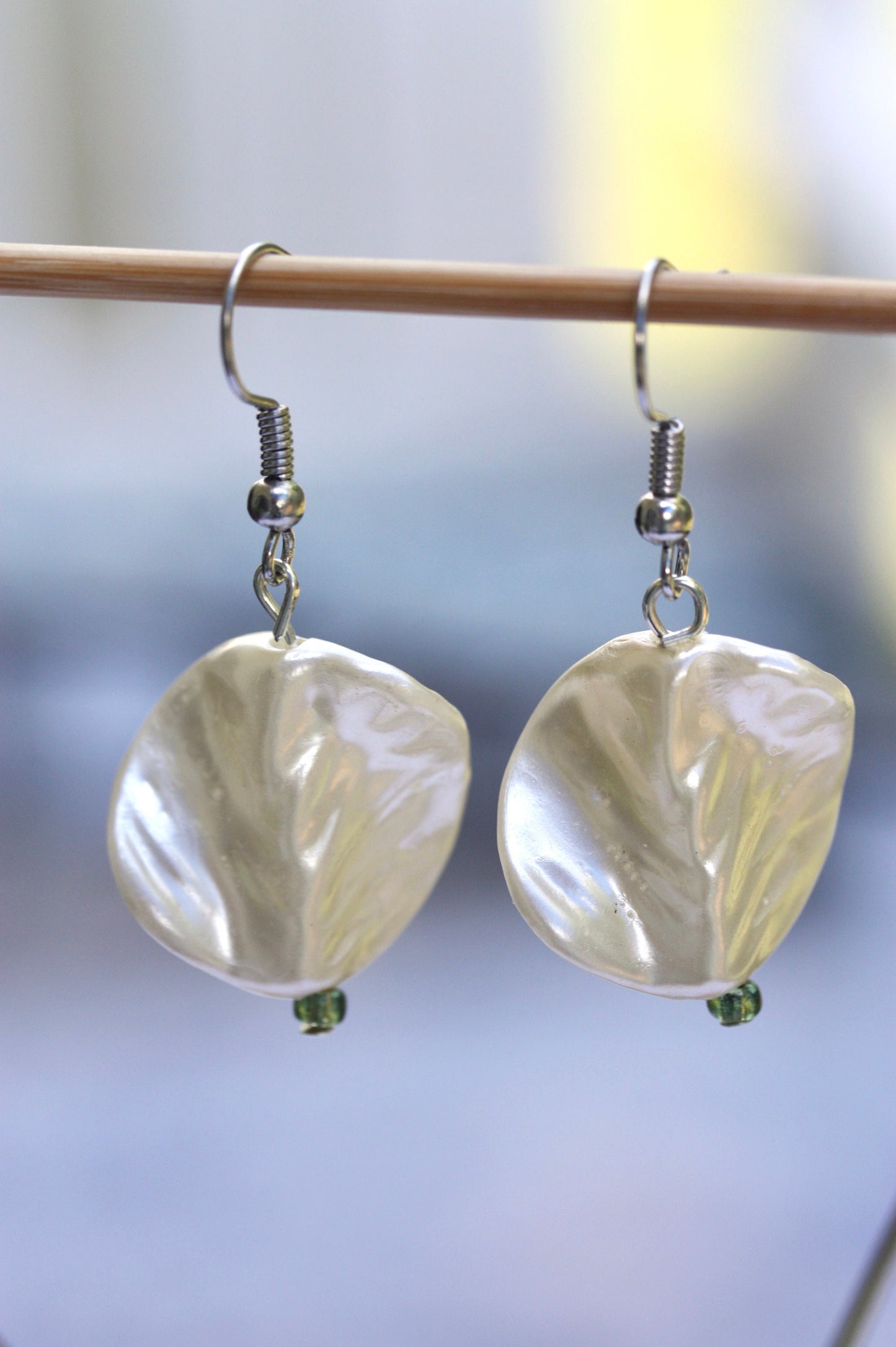Pearlescent leaves dangle earrings trimmed with tiny sparkly seed beads