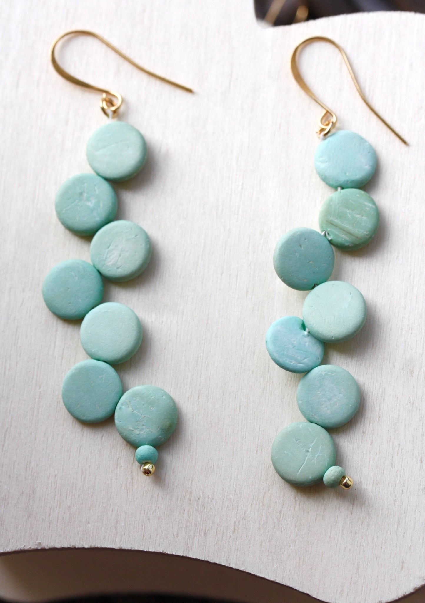 Handsewn aqua tinted wooden disk Scandinavian-inspired earrings - with sloped goldstone ear wires