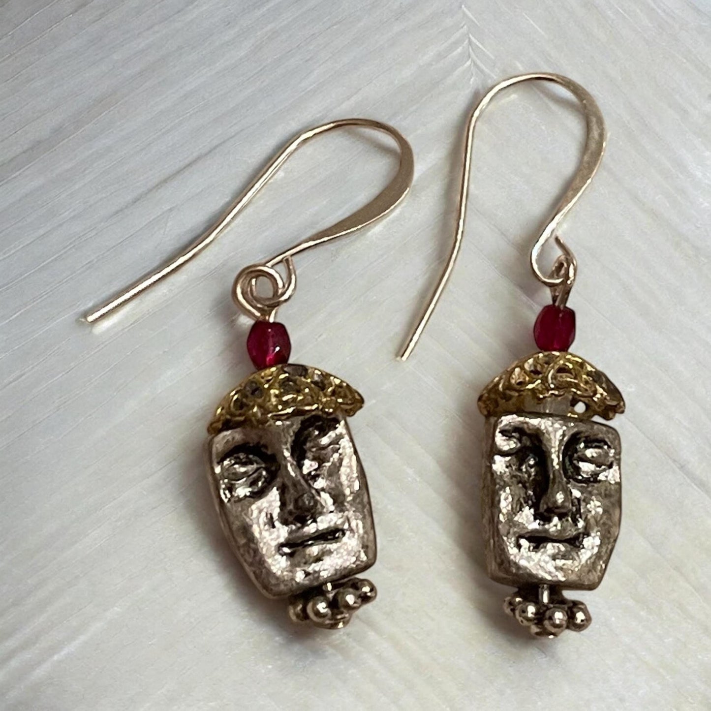 Unique silver tone face earrings with mixed metal and red crystals