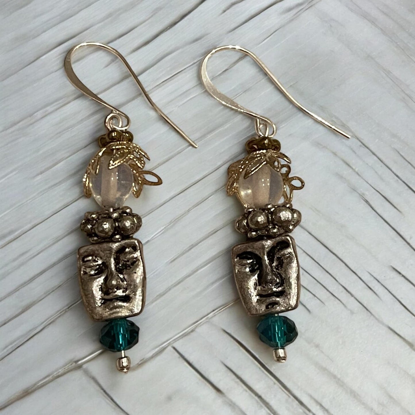 Unique silver tone face earrings with mixed metal and blue crystals