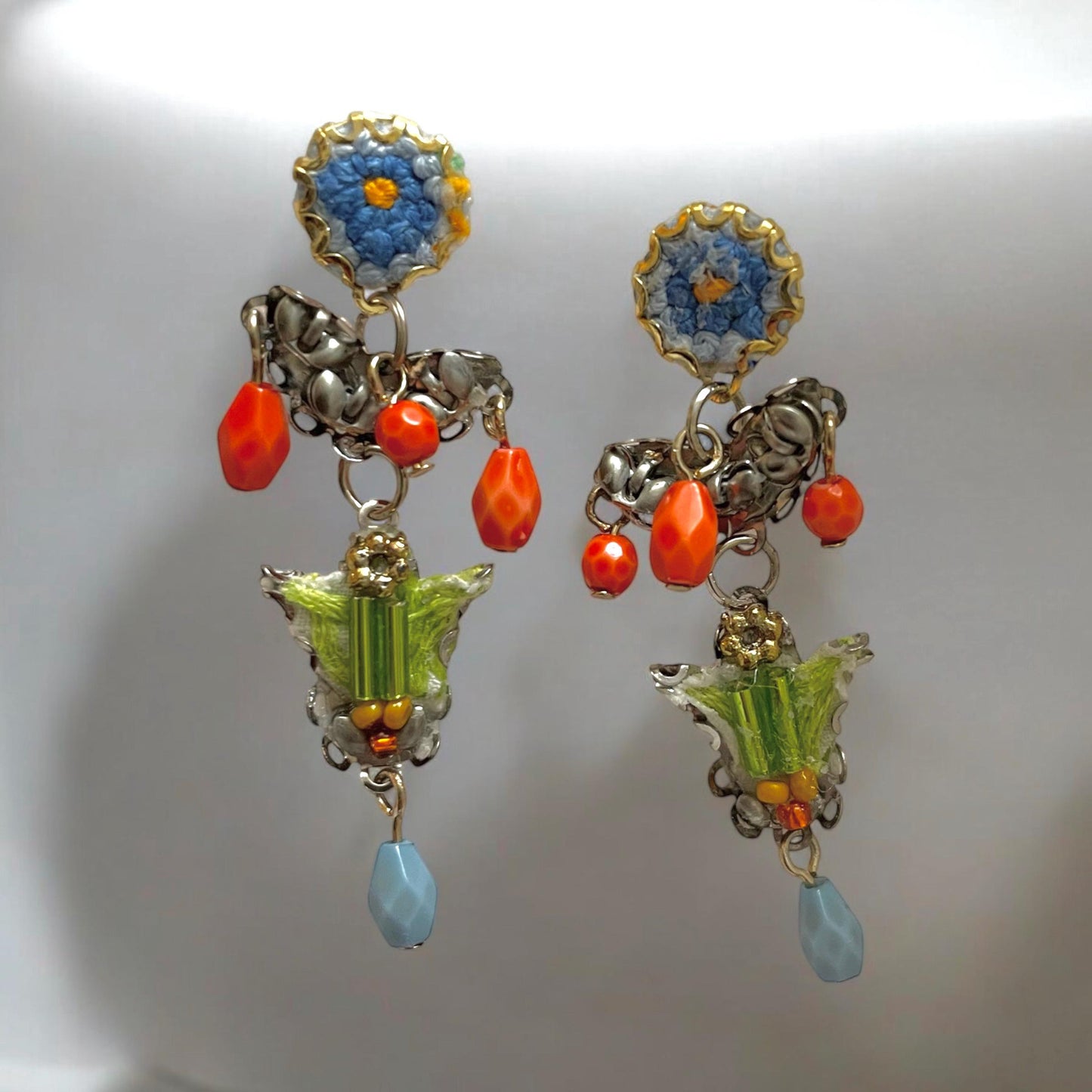 Handmade mixed media earrings made with embroidery from a vintage linen table runner, combined with glass, plastic, metal & fabric elements