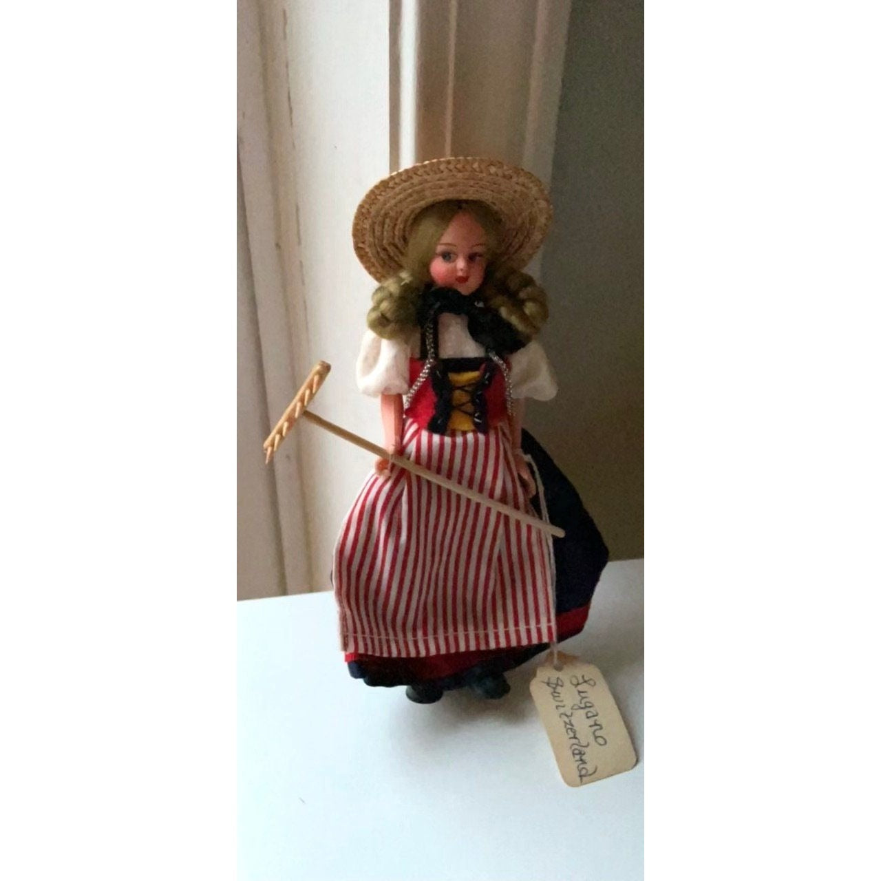 Vintage collectible handmade doll from Luganos Switzerland - with traditional handmade clothing and wooden rake