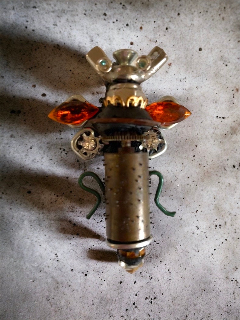 Meet "Scout" , a mixed material insect made of parts of a vintage Swiss music box, along with nails, screws, bolts - pin or necklace pendant