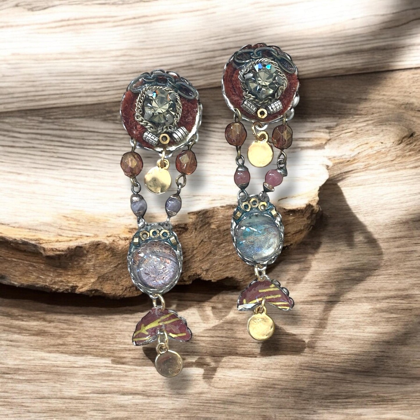 One-of-a-kind earrings made with, paper, fabric, velvet, rhinestones, chain, mixed metals and postage stamp remnants. Sterling ear wires.