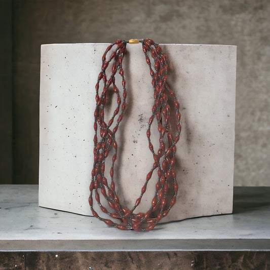 Three-strand necklace made of dozens of itsy bitsy extra tiny little rolled and sealed red paper beads