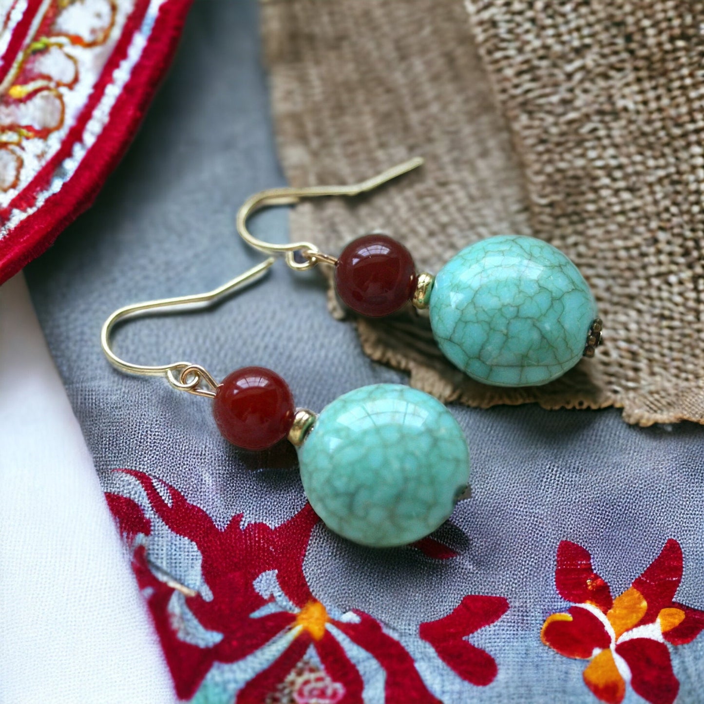Dangle earrings made of faux turquoise and deep red glass