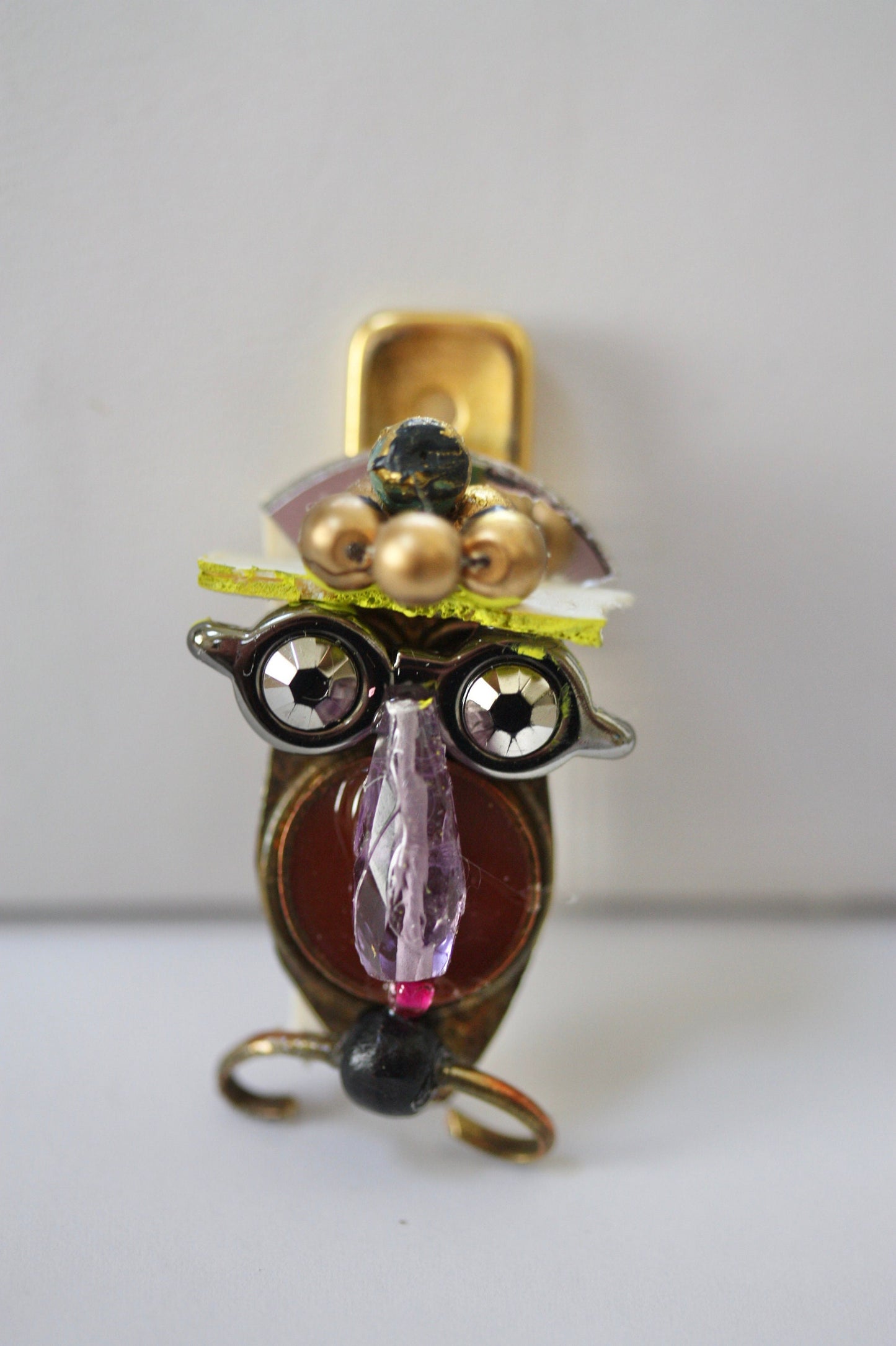Meet "Henrietta."  Henrietta is a really cool assemblage art gal who can be transformed into a necklace, pin, magnet, bottle or little dish